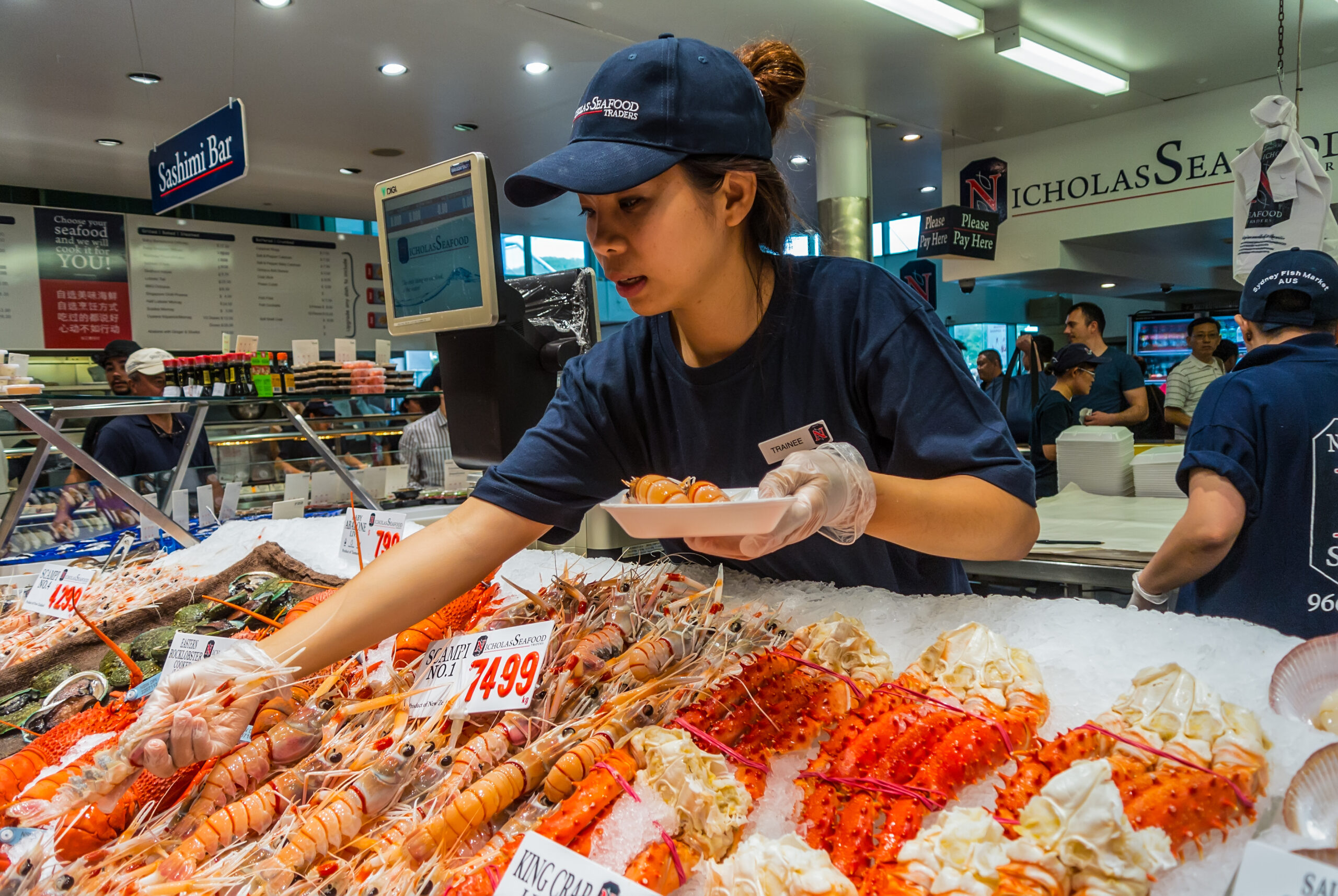 Female selling fish at the Sydney Fish Market, Sydney, New South Wales, Australia.